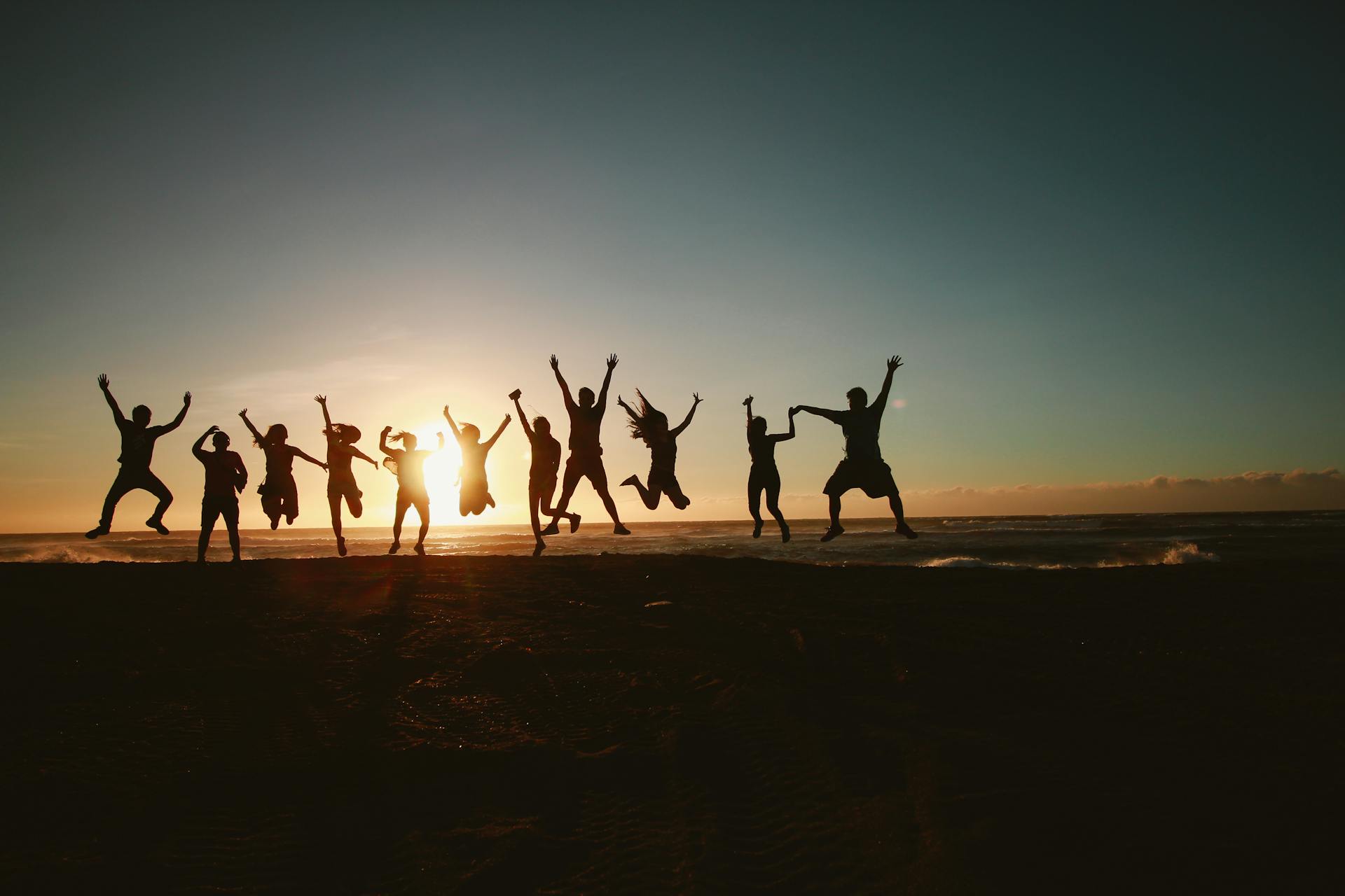 Silhouette Photography of Group of People Jumping
