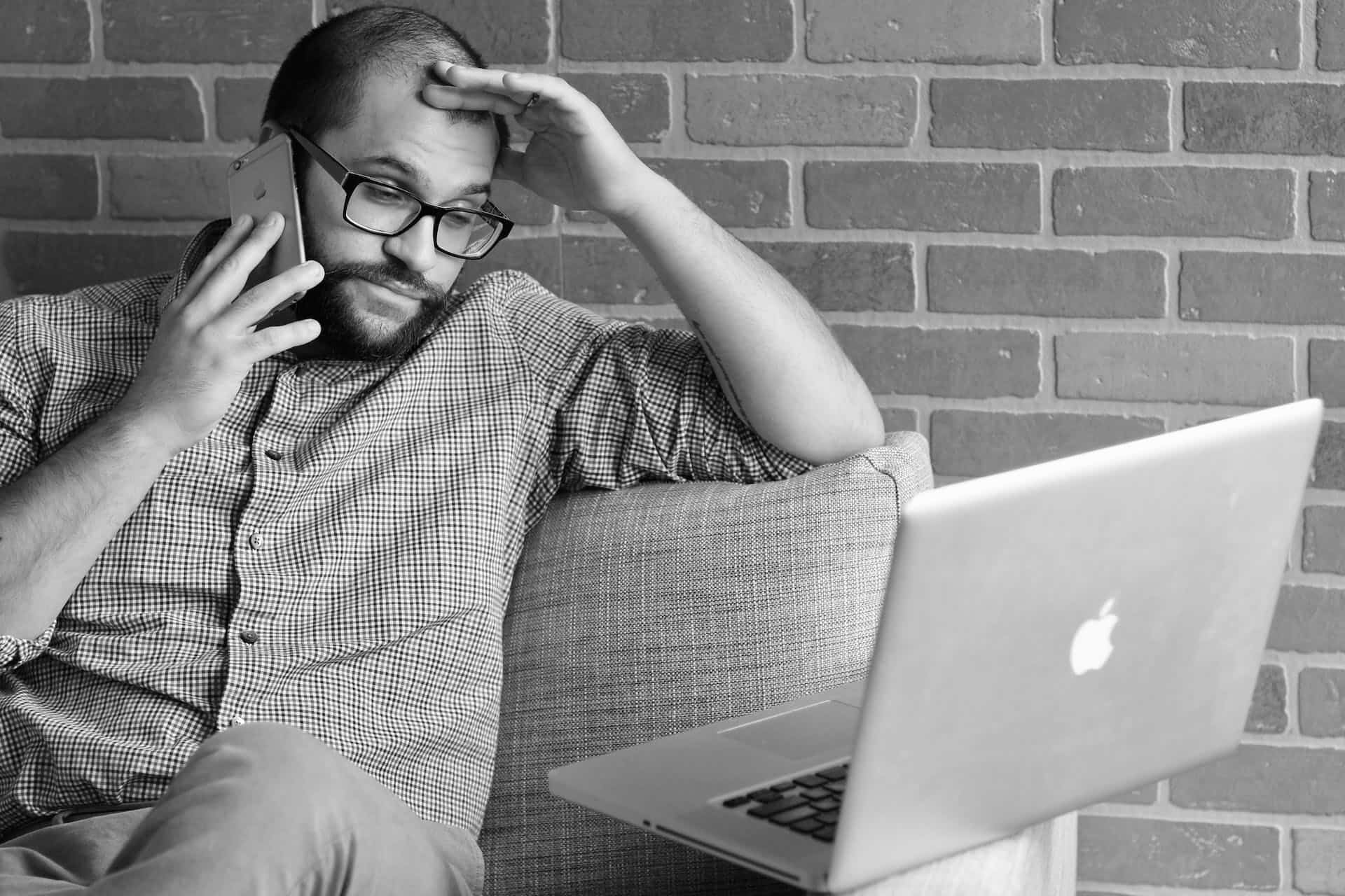 Man on the phone sitting on a couch